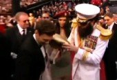 Sacha Baron Cohen Dumps Ashes On Ryan Seacrest On Red Carpet